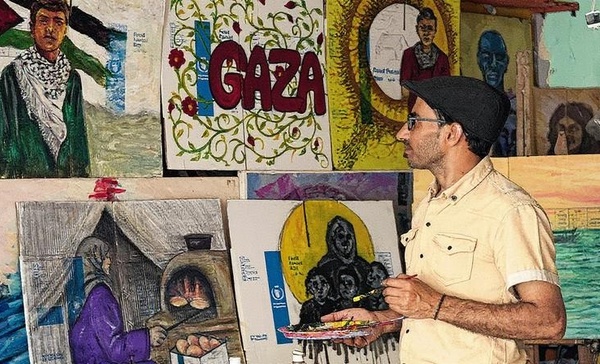 Palestinian Artist Exhibits Works Painted on Gaza Aid Boxes
